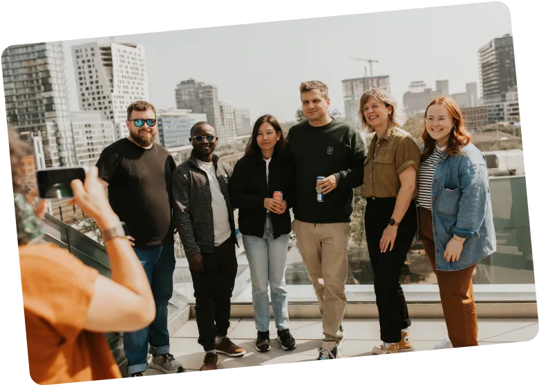 Photo of employees taking a photo on a rooftop terrace in Montreal