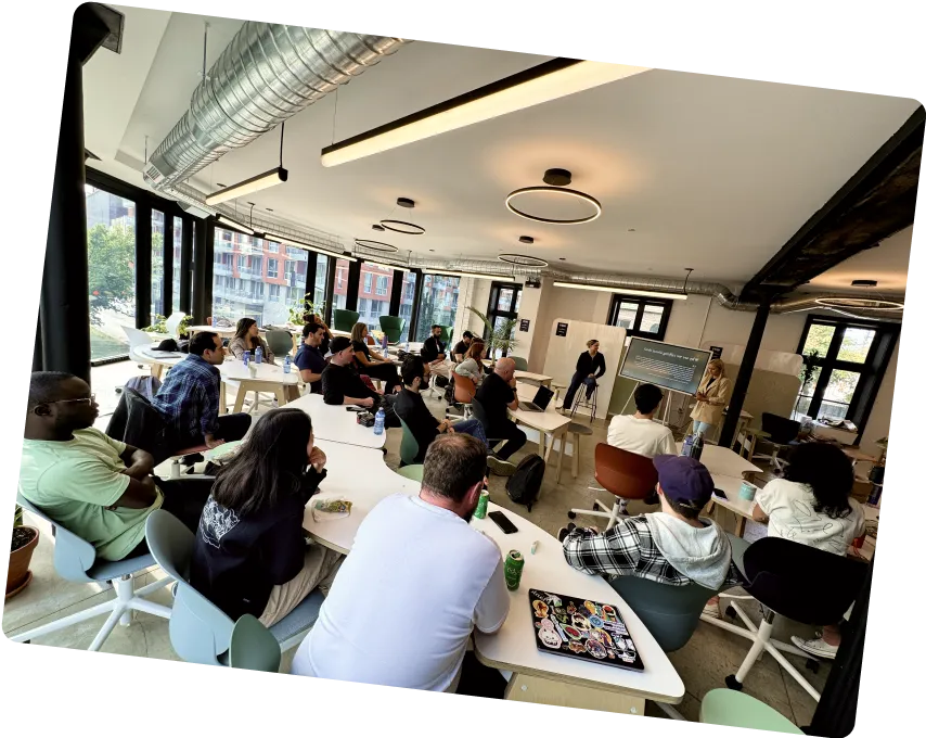 Photo of a room full of people listening to a talk